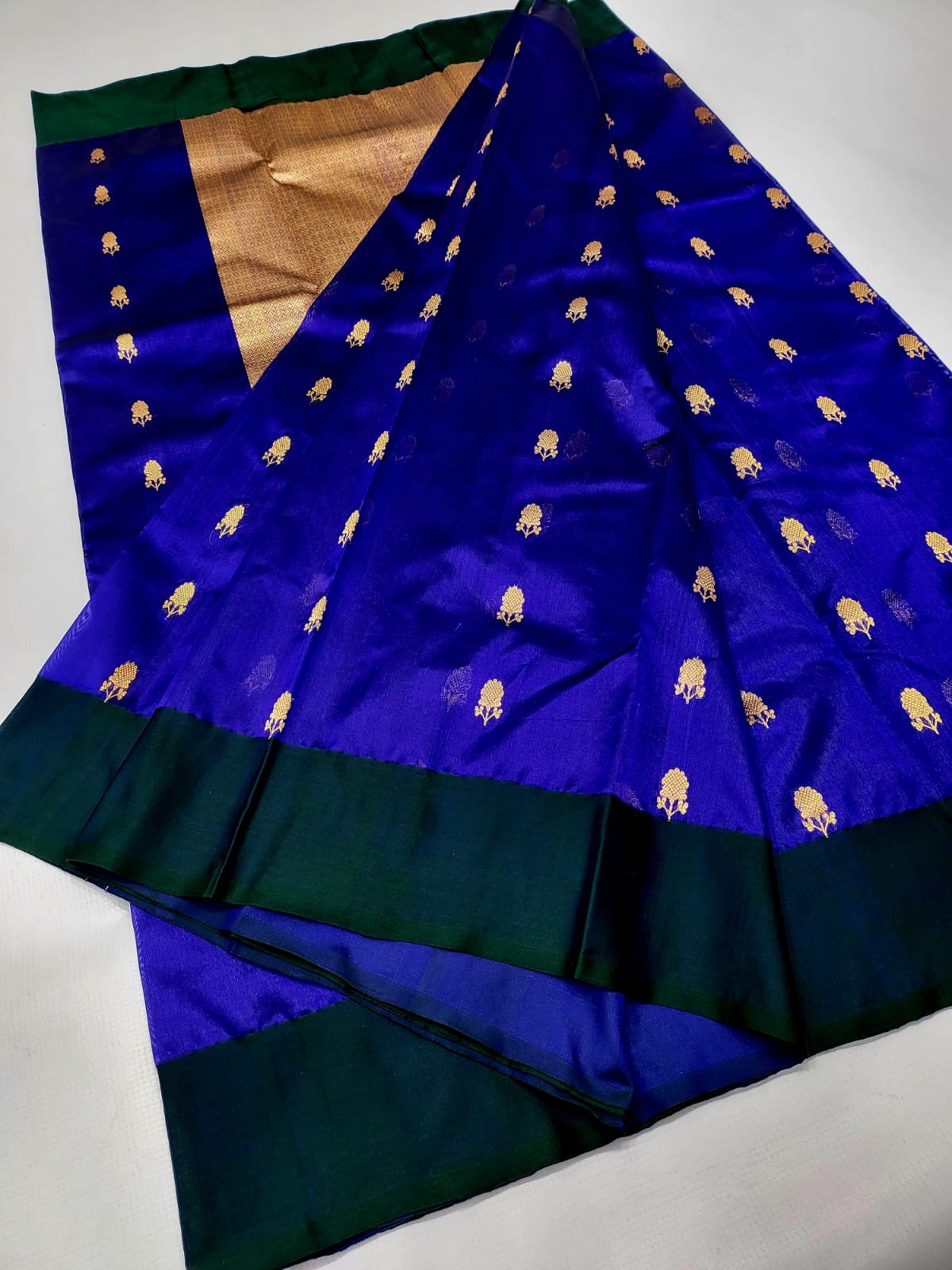 Gold floral butta motif close-up on royal blue Chanderi silk saree