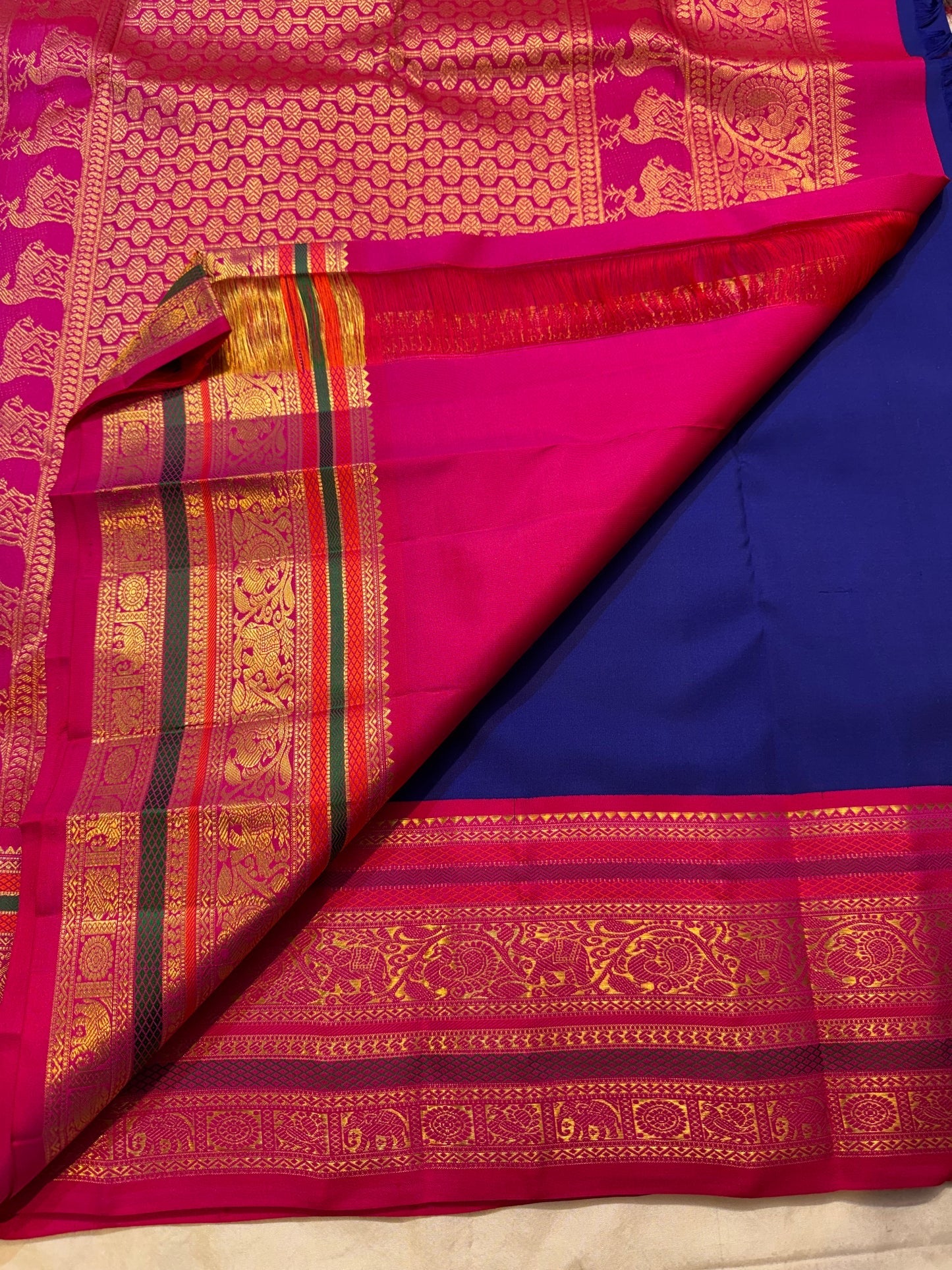 Royal Blue Pure Silk Kanchipuram Korvai saree with Rani Pink, green and elaborate gold zari border.