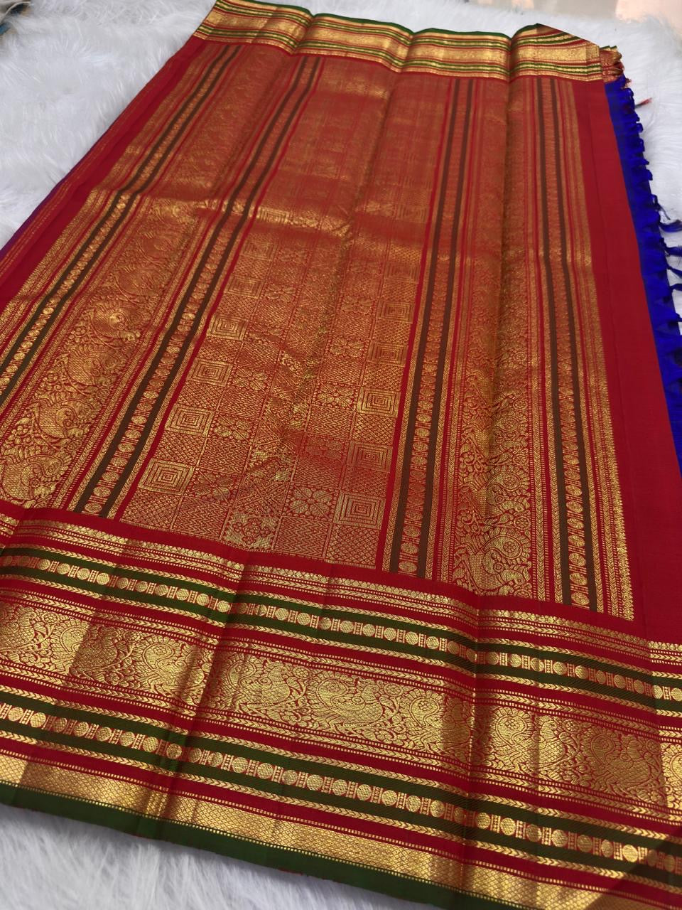 Peacock gold zari border detail, royal-blue Kanchi Pattu Korvai saree