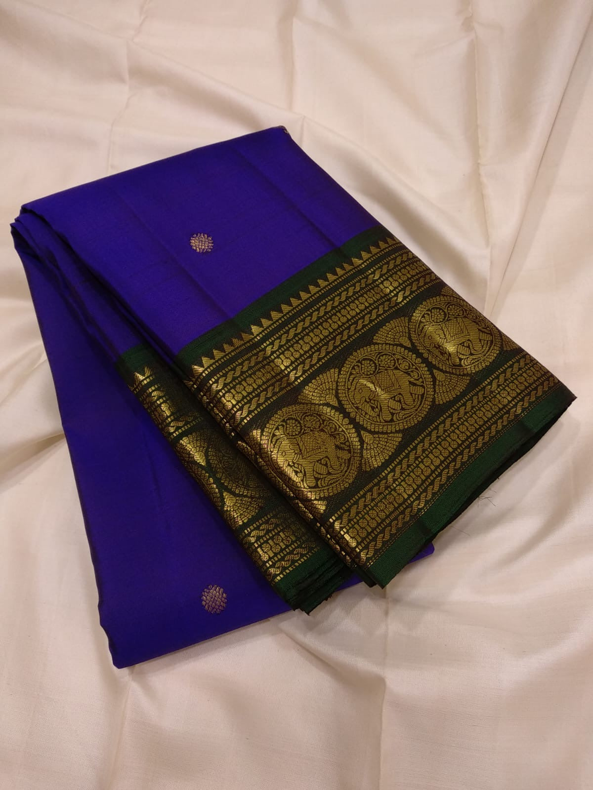 Royal-violet Kanchipuram silk with petite gold Mayil butta motifs.
