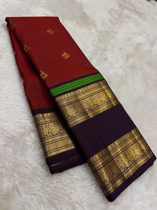 Handwoven Kanjeevaram Rettapet saree featuring deep jamun purple body and warm rust red selvedge