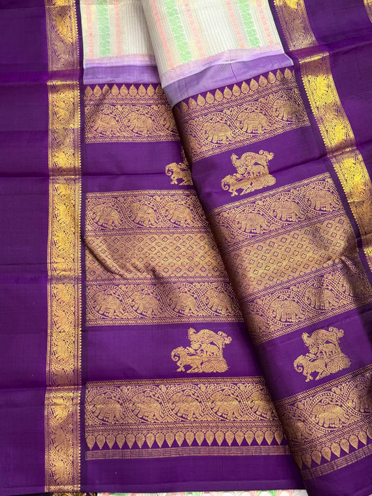 Royal purple Rettapet border with gold zari Yaanai motifs in floral framing on a Kanchipuram silk saree