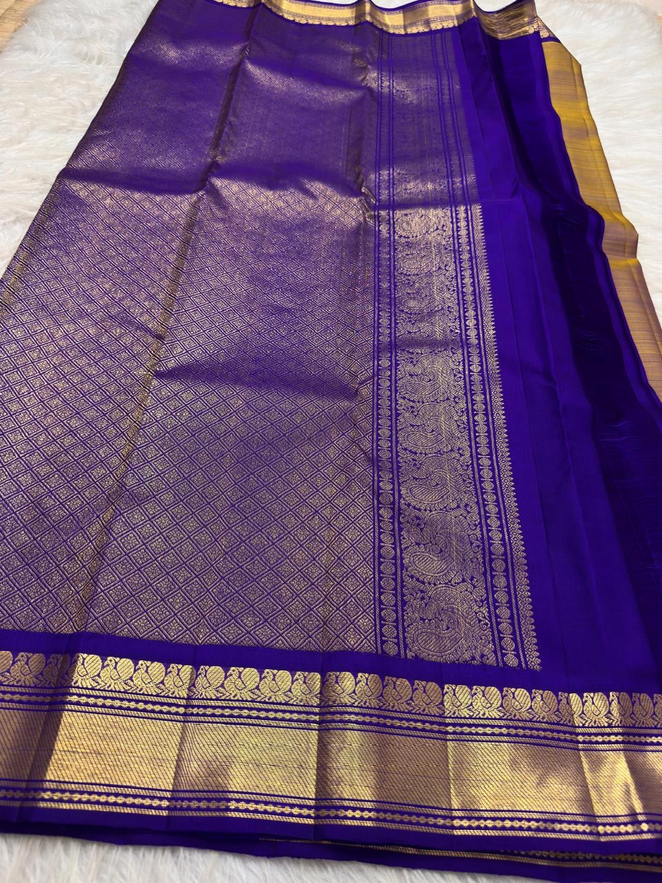 Royal violet zari border on a Kanchipuram Korvai saree in burnished mustard gold