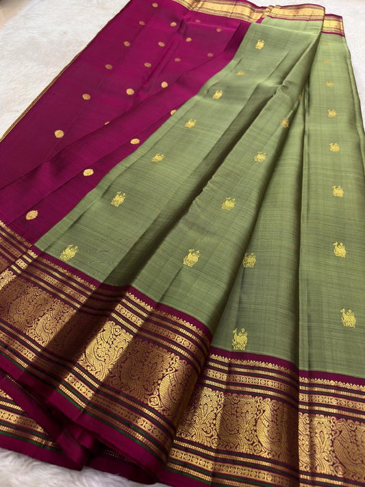 Sage green Kanchipuram silk saree with traditional gold zari border detail