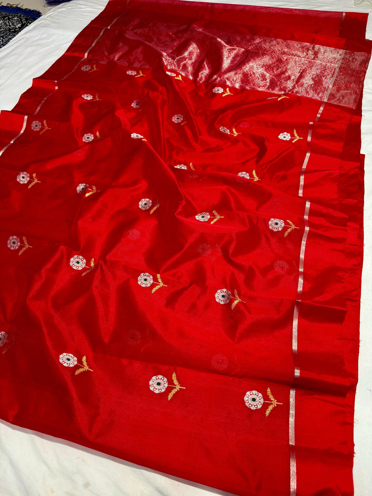Detail of the vermilion red Chanderi silk body with floral buta motifs near the border