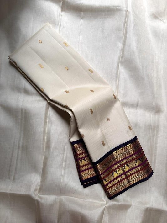 Ivory Kanchipuram silk saree featuring classic varisaipet gold zari border and traditional woven motifs