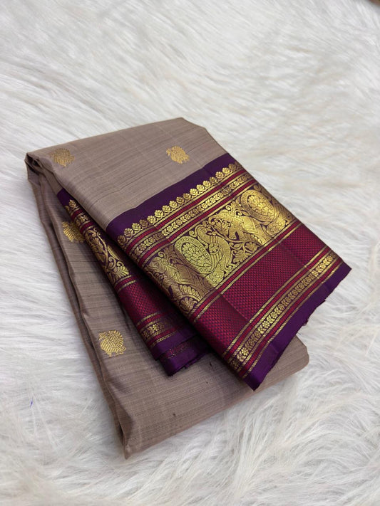 Taupe Brown Kanchipuram silk body with spaced gold zari buttas and richly woven purple Varisaipet border.