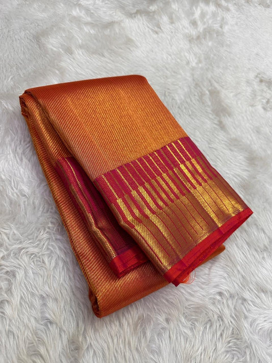 Very thick orange pure silk saree showing a luminous grid and expansive magenta border