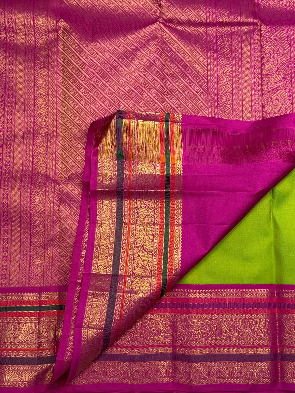 Pure silk Kanchipuram saree in Thulir Pachai Green with Magenta Pink, traditional handwoven border and zari detail