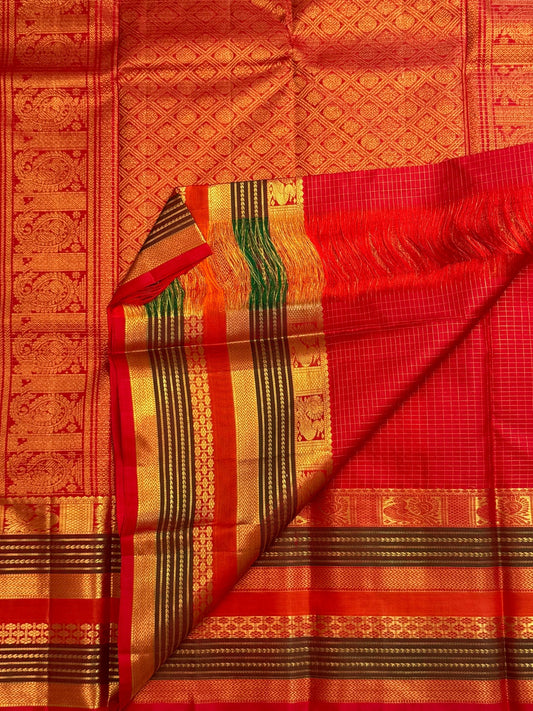 Radiant vermilion red reminiscent of temple kumkum pure silk Kanchipuram saree, yaanai elephant zari butta detail; traditional Zari Kattam weave.