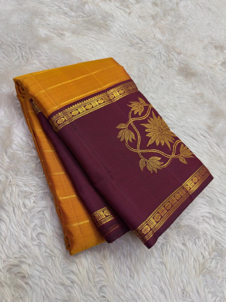 Turmeric gold Kanjivaram saree with Vadamalli plum border and zari body.