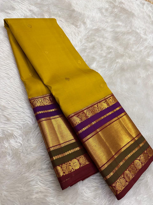 Turmeric gold Kanjivaram silk saree with sunlit gold zari and purple contrast