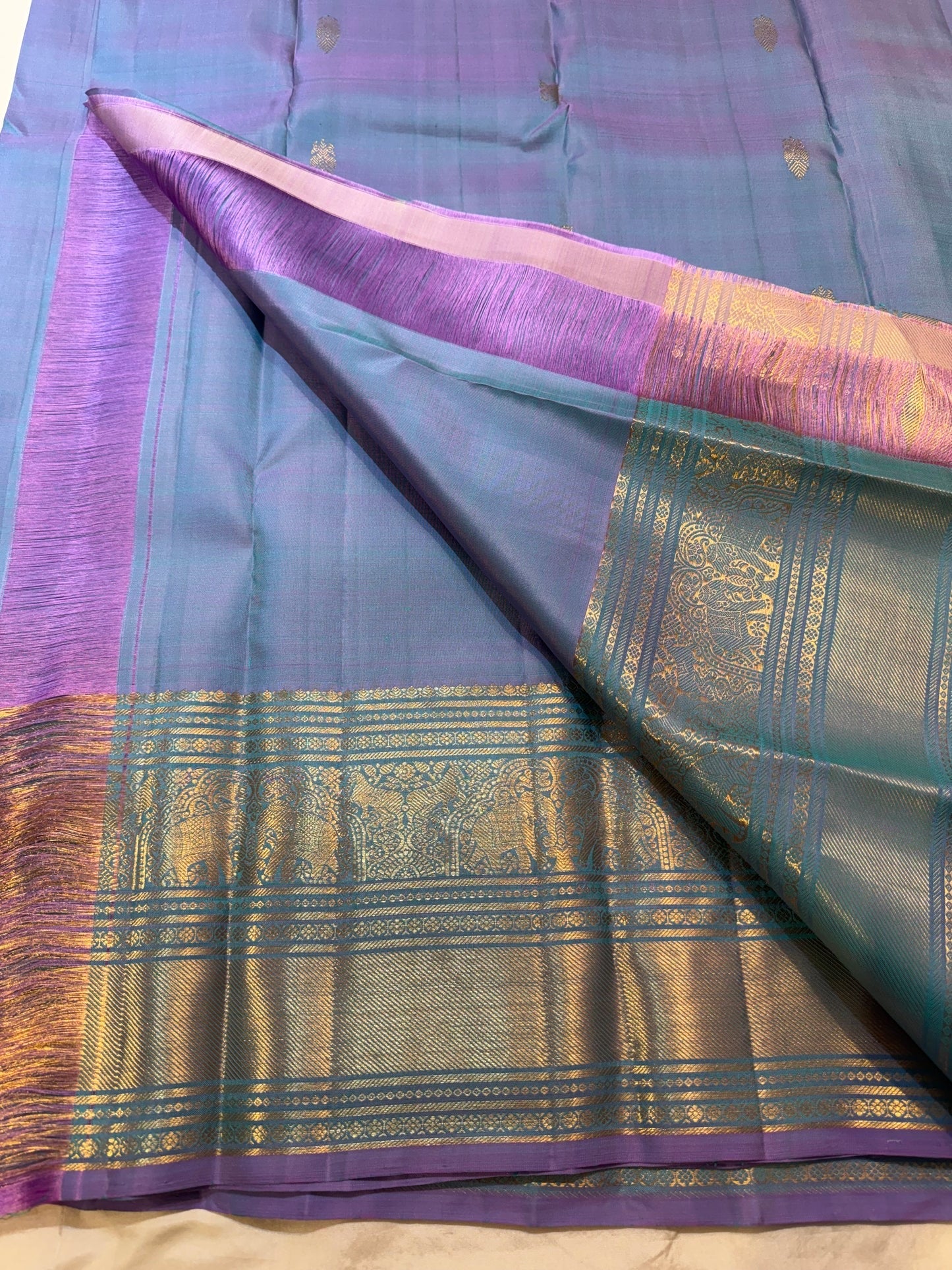 Folded Twilight Periwinkle Kanjivaram silk saree showing Gandaberunda zari butta pallu detail