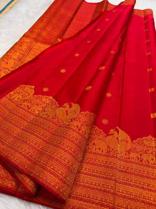 Vermilion Red KanchiPattu silk saree body close-up with gold zari floral butta motifs