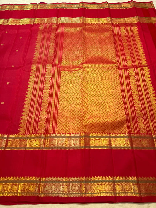 Vermilion Red pure silk Kanjeevaram Rettapet saree with spaced gold zari buttas and traditional gold border.