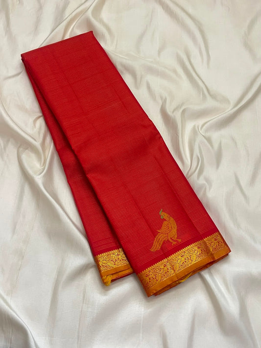 Vermilion red Vairaoosi Kanchipuram saree with Mayil zari motif, close-up