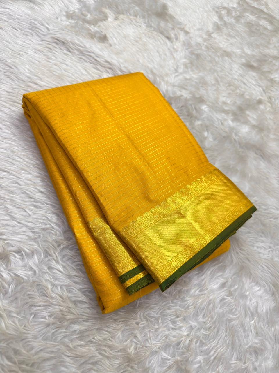 Close-up of yellow silk body showing radiant Zari Kattam gold grid on thick-ply pure mulberry silk