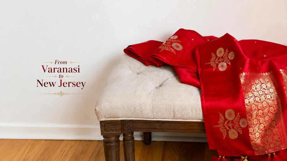 Blog banner showing a red Banarasi silk saree draped on a neutral bench with the text “From Varanasi to New Jersey.”