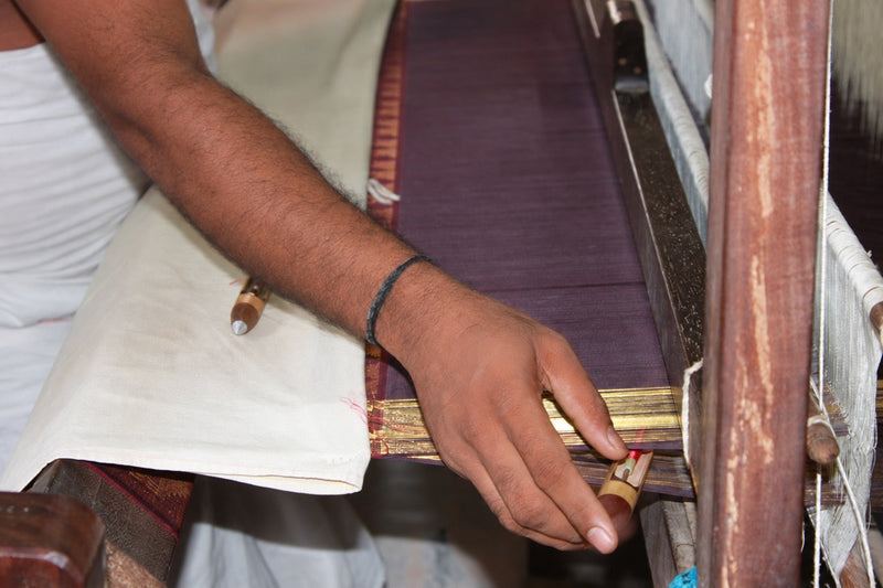 Weaver at a traditional pit loom in Kunnam village near Kanchipuram, Tamil Nadu