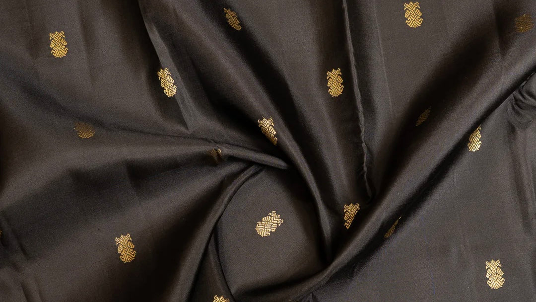 Kanchipuram pure silk sarees with handwoven gold zari butta motifs including peacock, lotus and coin designs