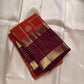 Cinnamon Kattam – Pure Kanchipuram Silk Saree
Vermillion red body with gold kattam checks & floral  buttas
Contrast plum purple korvai borders with rich zari weave
Grand zari pallu with lattice & floral motifs in gold
Silk Mark Certified ships in 2weeks