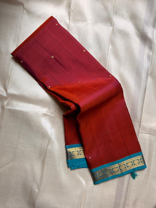 Komethagam Rama ✨
Pure Kanchipuram Silk Saree in Ember Red & Rāmar Blue
Ember-red body with gold zari buttas – gemstone inspired
Contrast Rāmar-blue border with chakra & vine motifs

Silk Mark Certified, delivery in 2 weeks