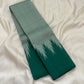 Deep emerald green and misty sage pure silk Kanchipuram saree folded to display dramatic Thazampoo Reku Korvai pointed border detailing.