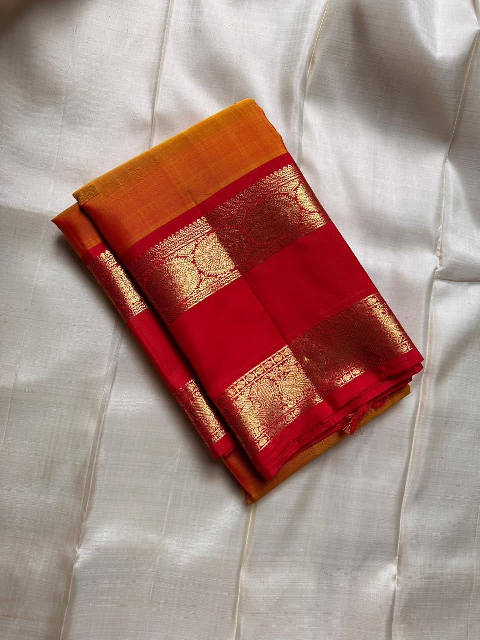 Pure Kanchipuram silk saree in mustard body with red rettapet border woven in traditional gold zari