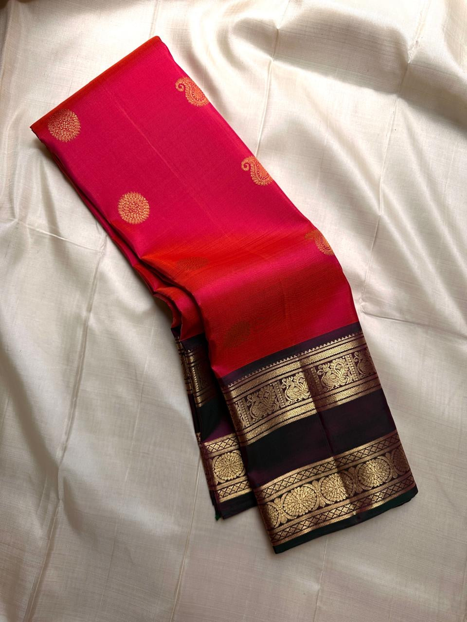 Vivid red  shot deep pink with coffee brown Mayil Kamalam rettapettu border and butta paisley Zari woven butta on body pure silk Kanchipuram saree
