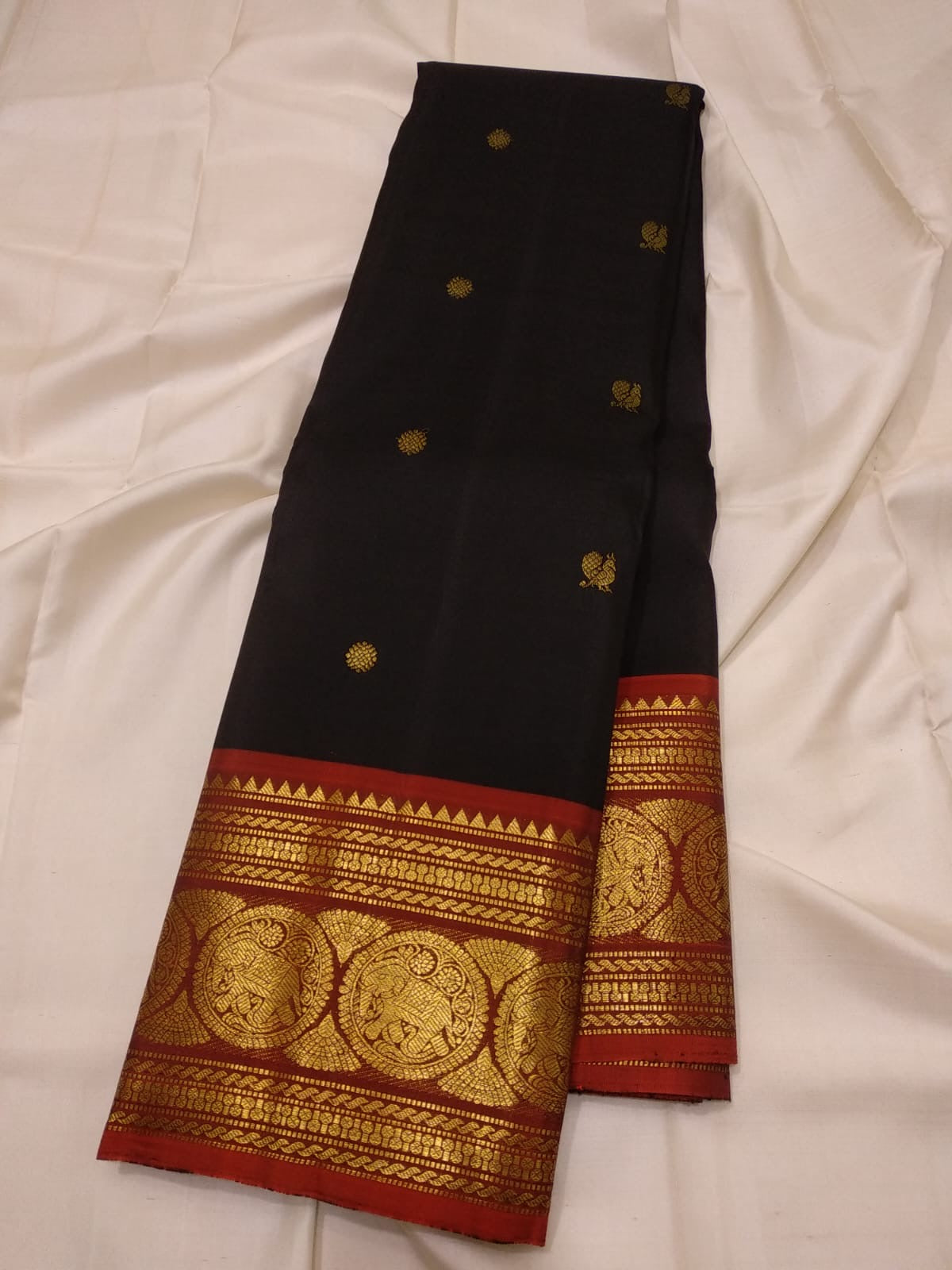 Full view of black pure silk Kanchipuram saree with red contrast border