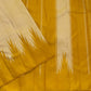Handwoven golden mustard Kanchipuram silk saree displaying contrasting sandalwood ivory Thazampoo Reku pointed motifs and a striped golden pallu.