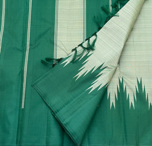 Handwoven emerald-green Kanchipuram silk saree featuring pale misty-sage body, traditional Thazampoo Reku Korvai forms and a green pallu with fine woven lines.