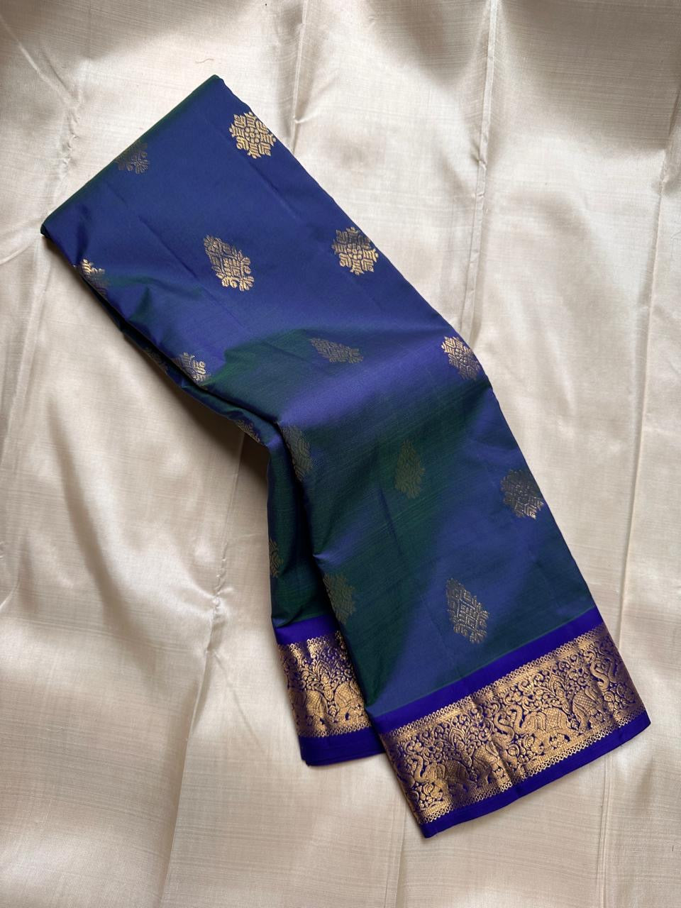 Swaram Lightweight – Peacock Dusk Blue
Feather-Light Peacock Blue Kanchipuram Silk Saree
Elephant & Tree of Life Zari-Woven Grandeur