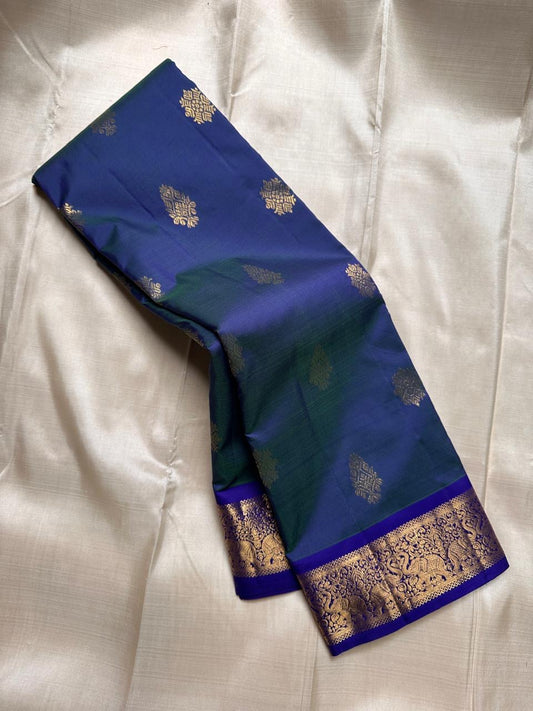 Swaram Lightweight – Peacock Dusk Blue
Feather-Light Peacock Blue Kanchipuram Silk Saree
Elephant & Tree of Life Zari-Woven Grandeur