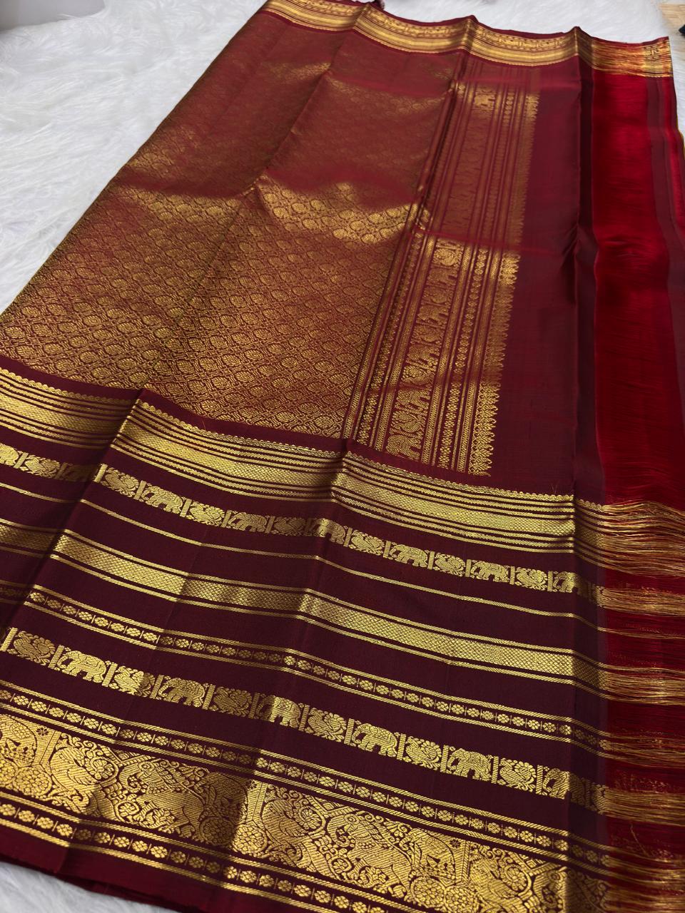 Dark Arakku pallu densely woven with gold geometric and floral zari on a turmeric yellow Kanchipuram saree