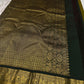 Olive Pachai – Pure Korvai Kanchipuram Silk Saree
Olive green body with gold zari gaja & medallion buttas
Contrast black korvai border with peacock & floral vines
Grand brocade pallu with lattice & temple patterns
Silk Mark Certified …chk description