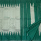 Traditional Kanchipuram Thazampoo Reku Korvai border with elongated emerald-green triangular forms against pale sage silk.