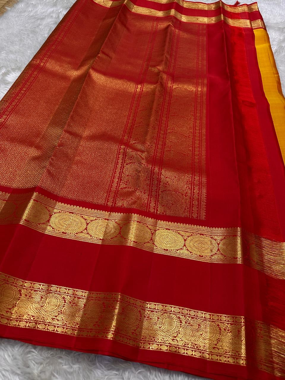 Festive red and mustard pure silk Kanchipuram saree folded display