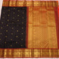 Traditional saree with black, gold, and red patterns on a white background