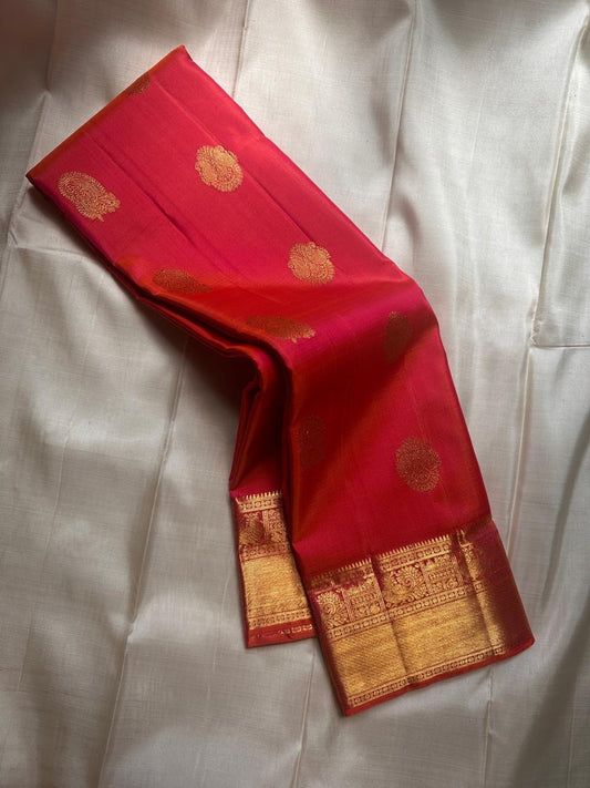 A blaze of silk in the richest shade of orange! Paisley zari woven motifs double border with mayil maadam and bavanji border