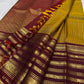 Turmeric yellow silk body with closely arranged oosivaanam gold zari lines