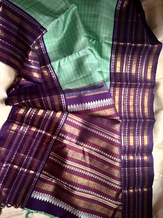 Sage Glory – Mint Green & Purple Kanchipuram Silk Saree ✨
Elegant Kattam Checks with Grand 3g zari Korvai Border
Rich Purple Pallu Woven with Traditional Motifs
Coordinated Blouse Piece with Matching Zari Finish

Silk Mark Certified, delivery in 2 weeks