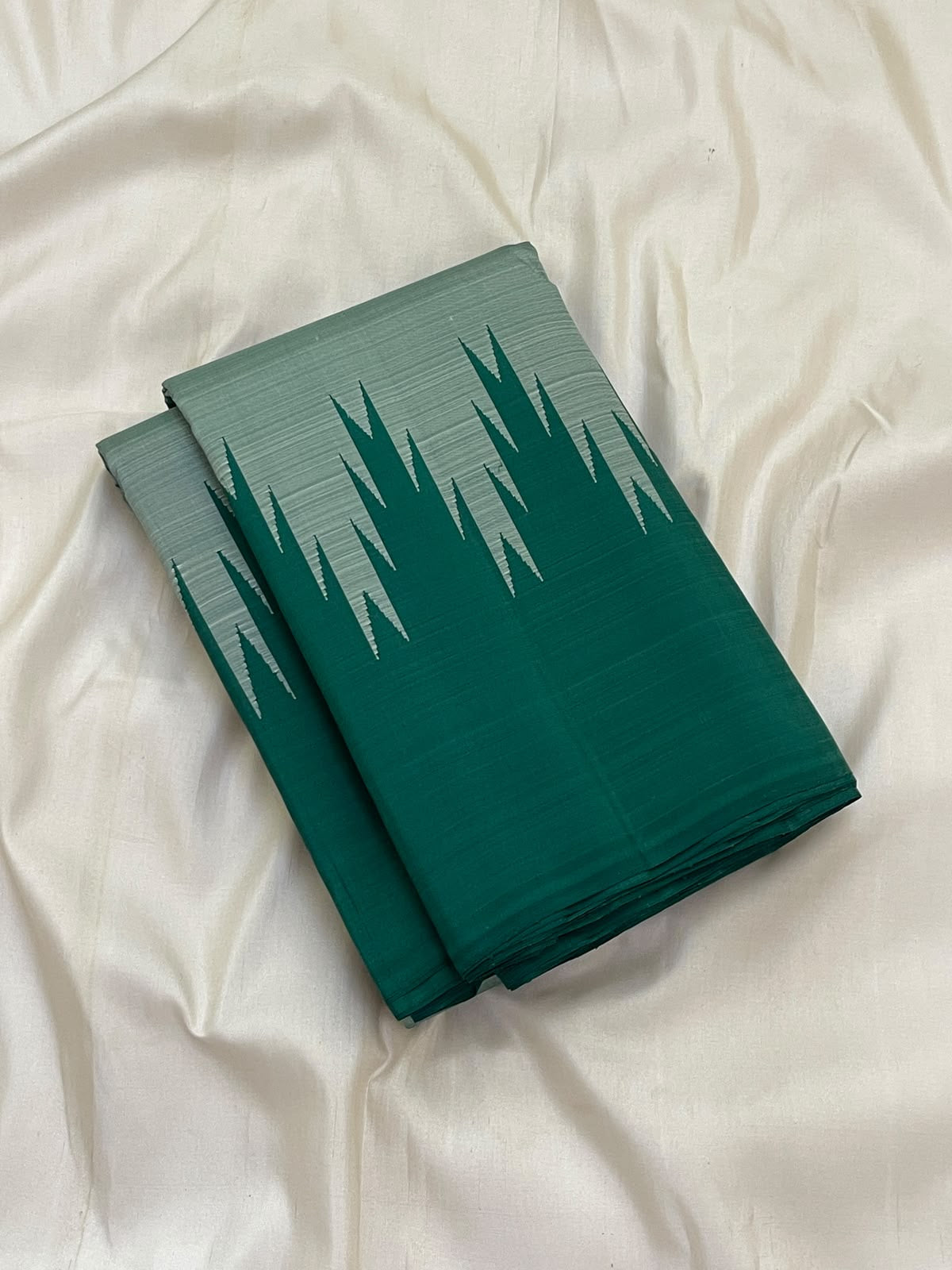 Emerald green and misty sage Kancheepuram pure silk saree with pointed Thazampoo Reku Korvai forms.