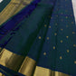 Full saree view showing teal body with gold buttas, deep blue accents, zari woven border and rich zari pallu with tassels