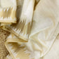 Minimal yet majestic, this ivory-beige silk saree is a celebration of simplicity and sophistication. The body is plain and luminous,  texture of the silk shines through. golden zari border with a sharp, zigzag temple-inspired pattern - perfect for Onam