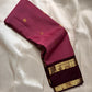 Maroon silk saree drape showing contrast coffee border with gold zari woven bands