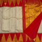Vermillion Venpattu Ettukol — Pure Kanchipuram Silk 
Ivory venpattu body with fine red temple -motifs in ettukol weaving 

Vermilion-red &gold korvai temple (reku) borders

Mullai moggu woven motifs on body  

Silk Mark Certified | Free Shipping within US