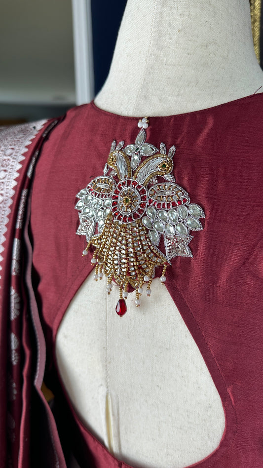 Maroon silver and gold Saree with peacock motif embroidery embellished with temple jewelry style stone work