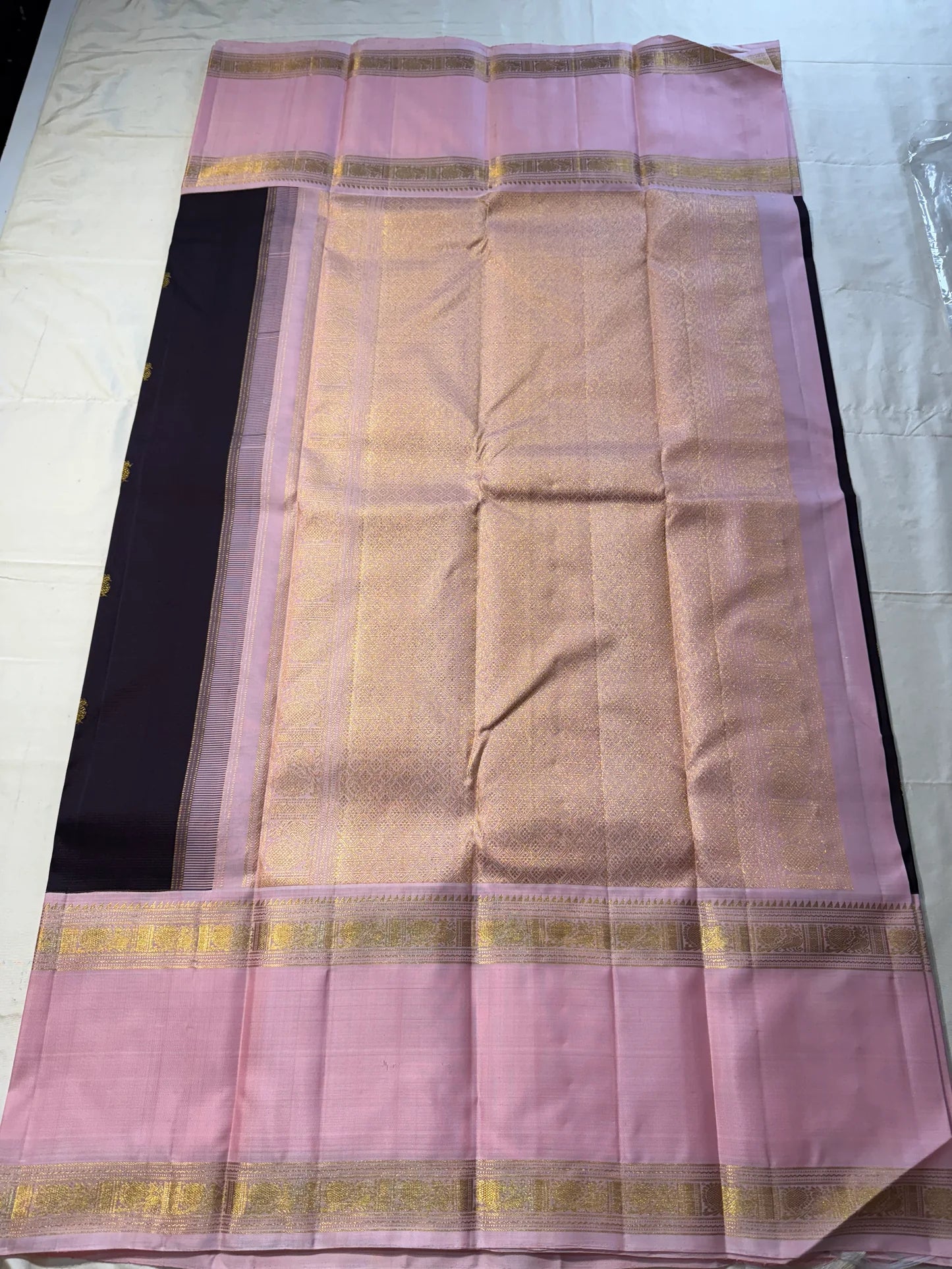 Rose Twilight – Pure Kanchipuram Silk Saree
Pastel Rose-Pink border with Golden Zari Weaves
Deep Plum-Violet Base Scattered with Gold Buttas
French Rose Rettapet Border in Lustrous Zari

Silk Mark Certified, delivery in 2 weeks