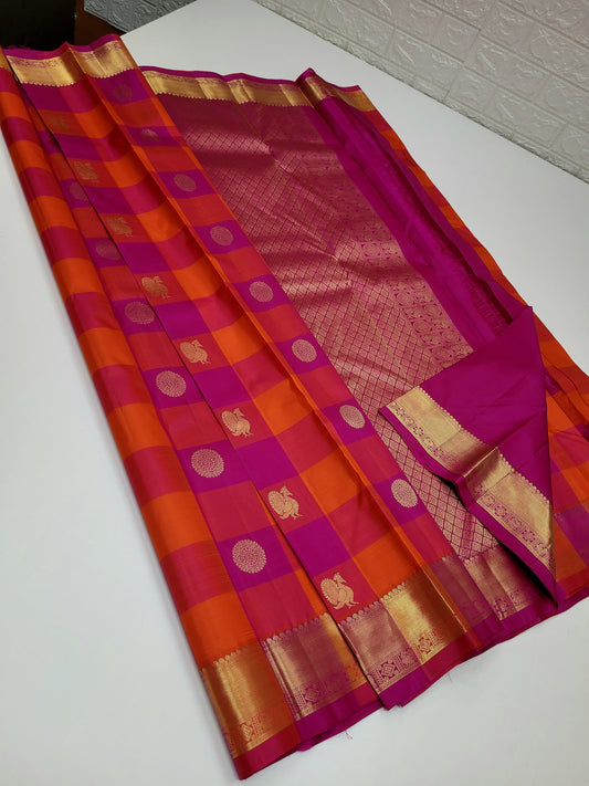 Laya – Paalum Pazhamum Checked Kanchipuram Silk Saree
Bathed in the serene hues of pink, magenta, and orange, Laya weaves tradition and vibrance through its classic kattam pattern, adorned with delicate Mayil Chakram buttas .